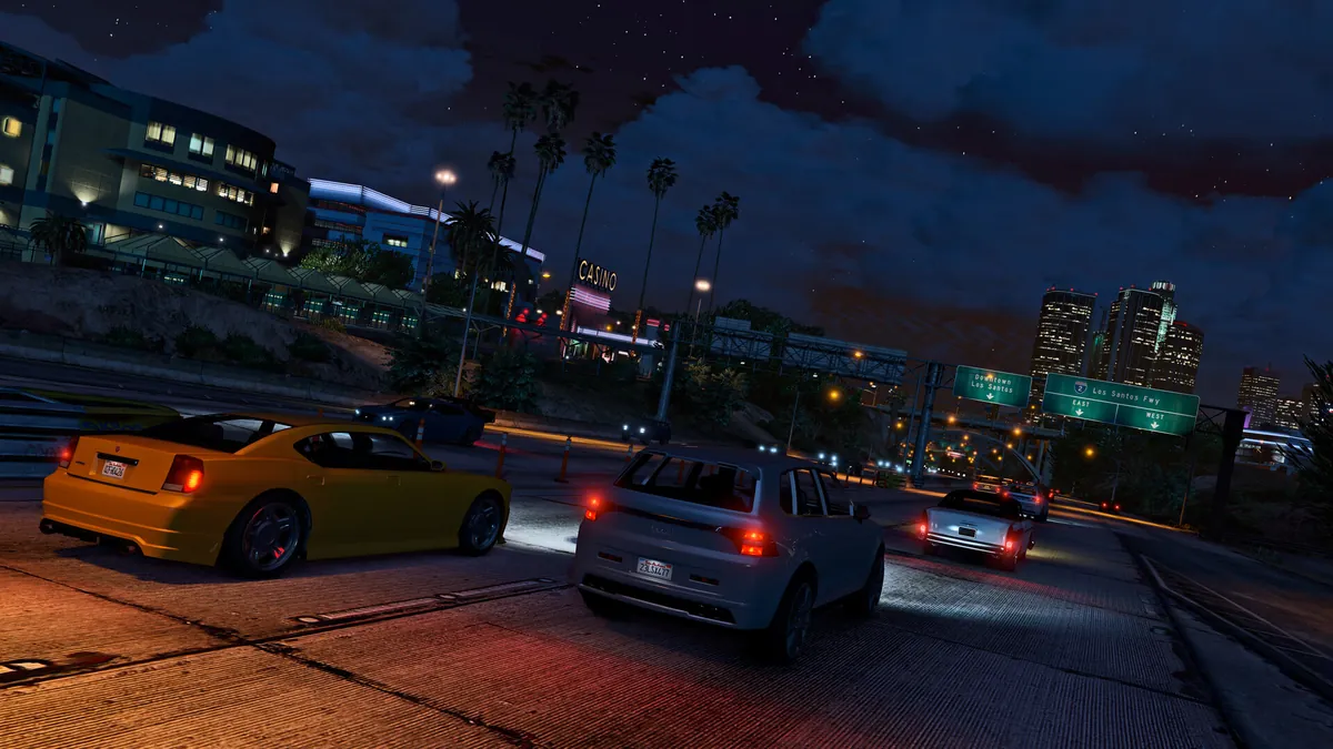 Tuned cars racing at night through Los Santos